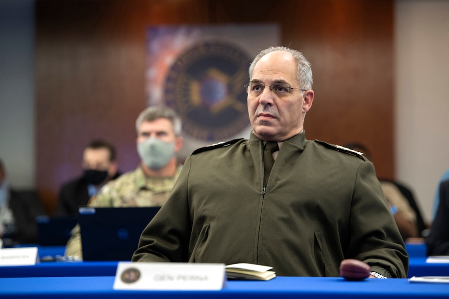 A military officer watches a simulated exercise.