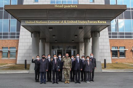 Gen. Robert B. "Abe" Abrams and members of South Korea's National Assembly Defense Committee pose in front of UNC and USFK Headquarters.