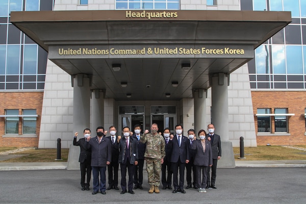 Gen. Robert B. "Abe" Abrams and members of South Korea's National Assembly Defense Committee pose in front of UNC and USFK Headquarters.