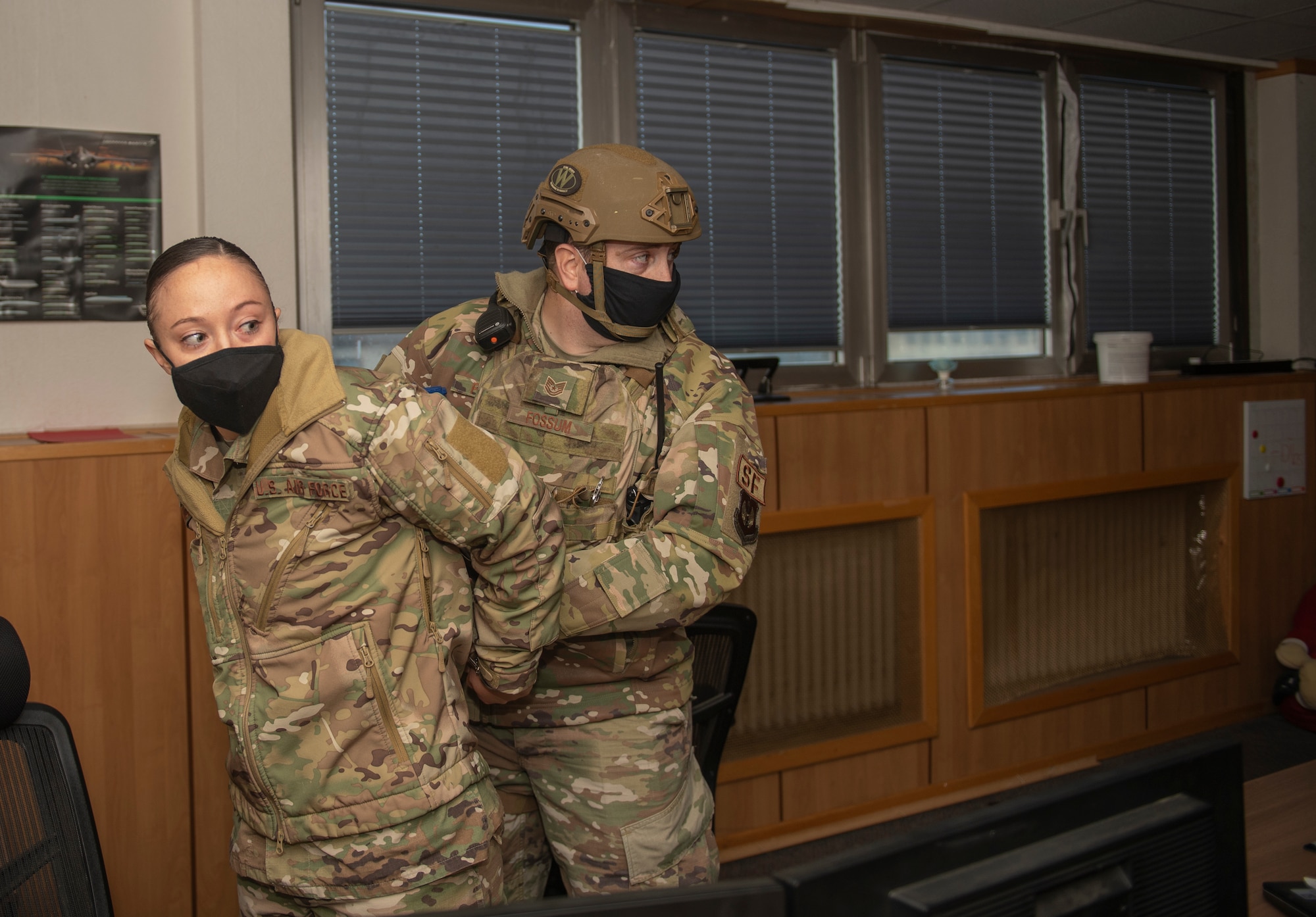 U.S. Air Force Tech. Sgt. Brian Fossum, 52nd Security Forces flight sergeant, right, apprehends Staff Sgt. Shealyn Kunze, 52nd SFS resource protection NCOIC, who posed as an active shooter during a base-wide exercise at Spangdahlem Air Base, Germany, Nov. 16, 2020. The active shooter exercise tested the response time of multiple base agencies and their ability to control the situation. (U.S. Air Force photo by Senior Airman Ali Stewart)