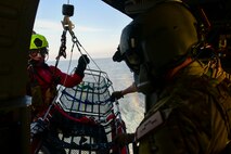 A photo of an Airman helping a PJ.