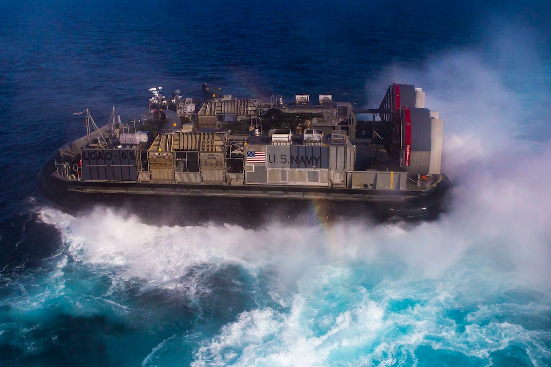 U.S. Sailors pilot Landing Craft, Air Cushion 6 while transporting Marines in support of a forward arming and refueling point operation, Oct. 12.