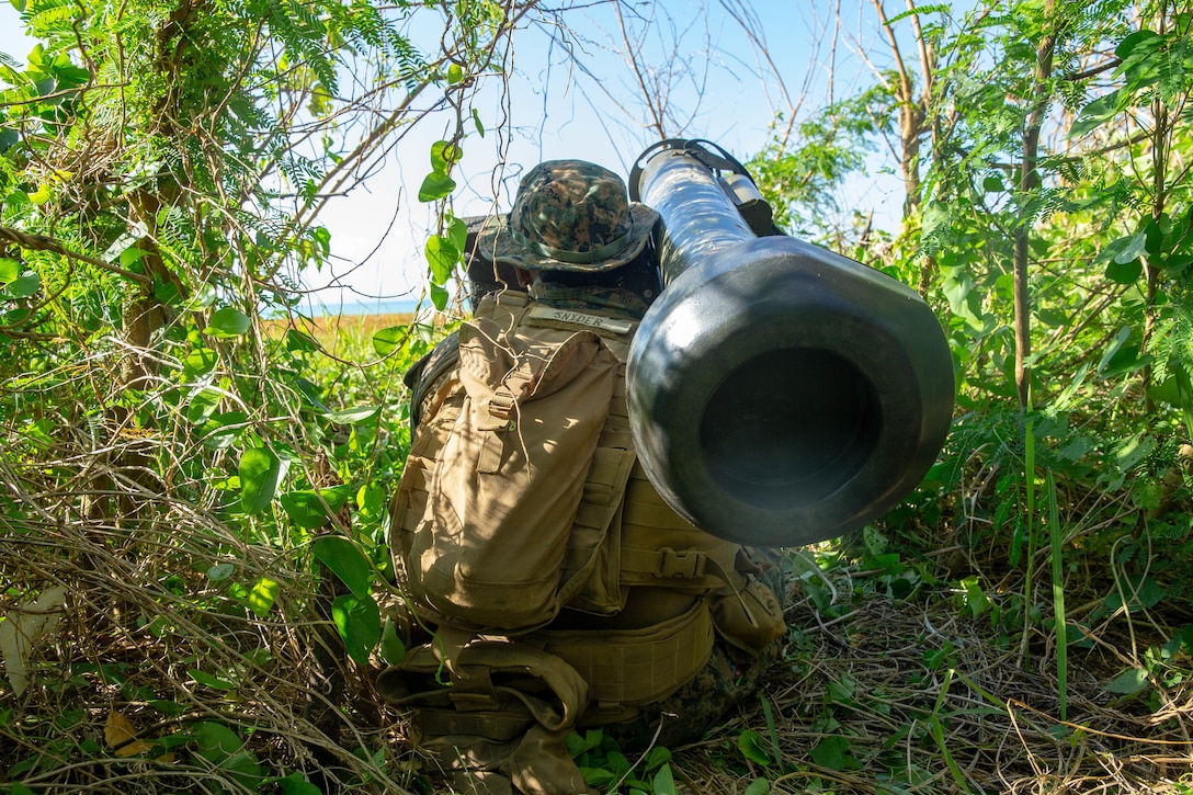 A U.S. Marine targets an enemy amphibious vehicle during a beach defense exercise at Kin Blue Beach, Okinawa, Japan, Oct. 10.