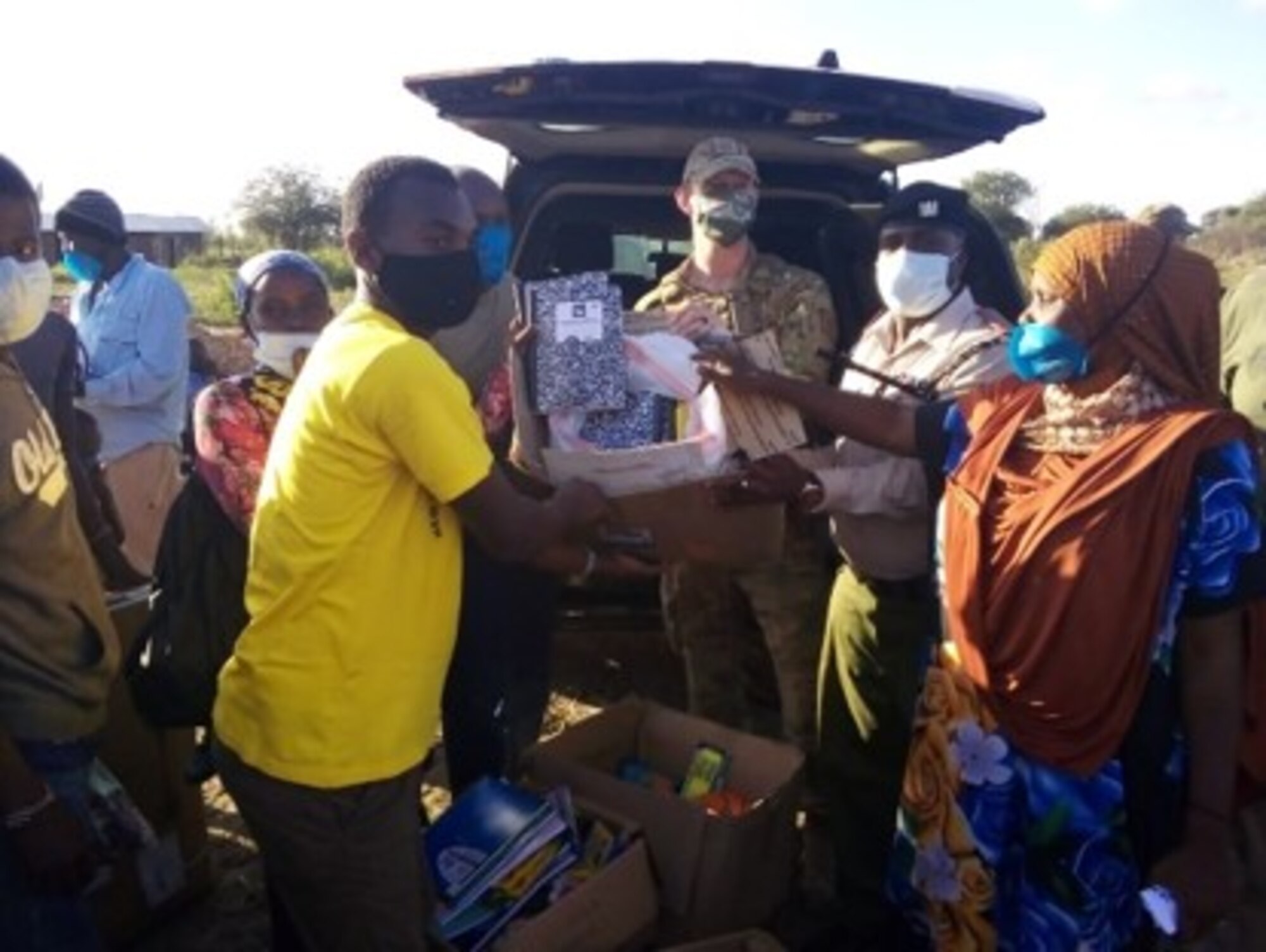 U.S. Air Force Capt. Ian Latham, 475th Expeditionary Air Base Squadron deputy force commander, presents school supplies for the teachers to gift to students when school opens back up in Magogoni Village at Manda Bay, Kenya, Nov. 6, 2020.