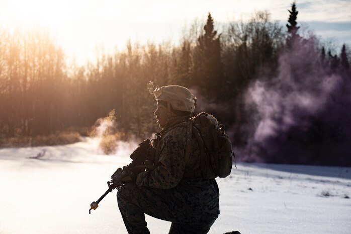 A U.S. Marin holds security during a simulated raid as part of Exercise Red Flag-Alaska at Eielson Air Force Base, Alaska, Oct. 16.