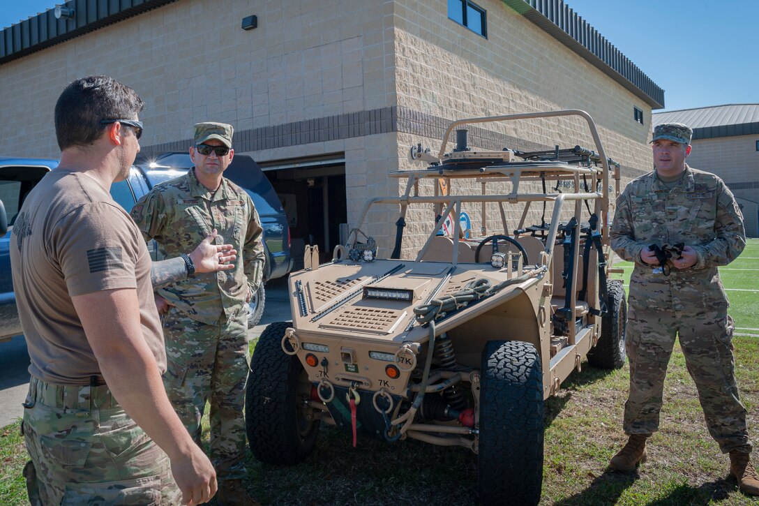 Photo of an Airman explaining storm search and rescue vehicle features