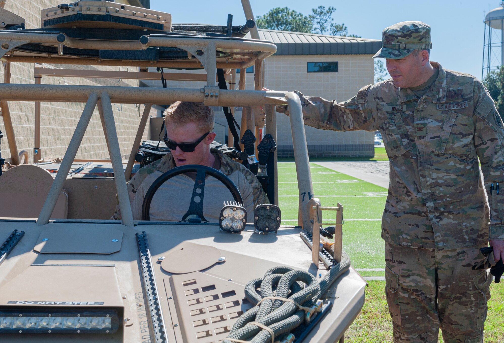 Photo of an Airman showing Col Walls storm search and rescue vehicle controls