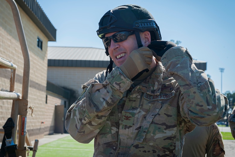 Photo of Col Walls putting on a helmet