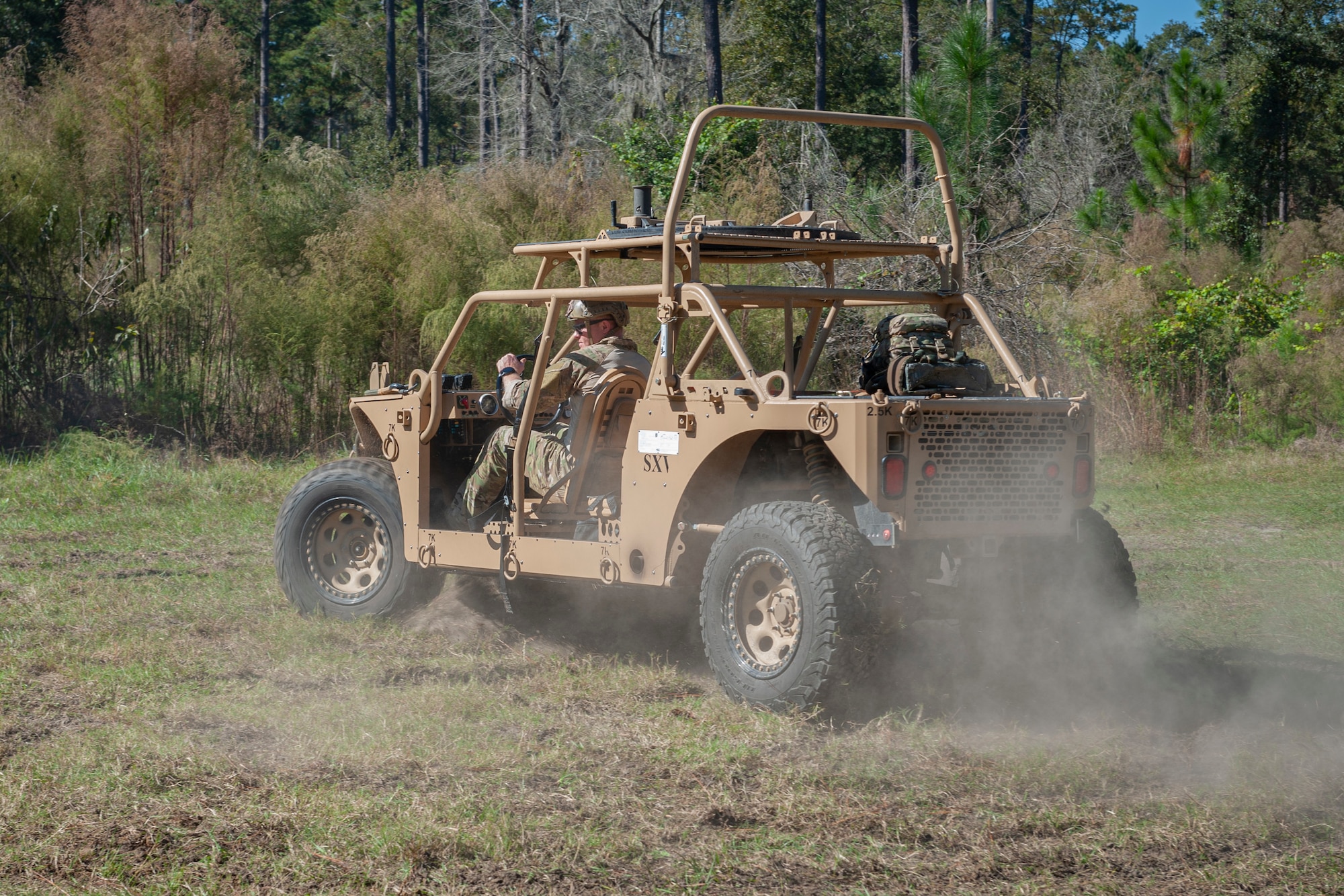 Photo of an Airman driving a storm search and rescue vehicle