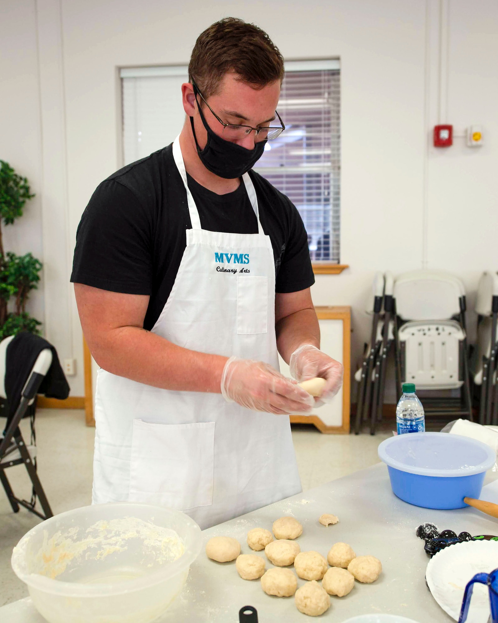 Airman 1st Class Hunter Breaux, 16th Training Squadron student, forms balls of dough to make tortillas during a cooking class, Nov. 7, 2020, on Holloman Air Force Base, New Mexico. With more people spending time in the home due to the COVID-19 pandemic, the class was livestreamed to allow Airmen and their families to participate in a fun activity while being COVID safe. (U.S. Air Force photo by Denise Ottaviano)