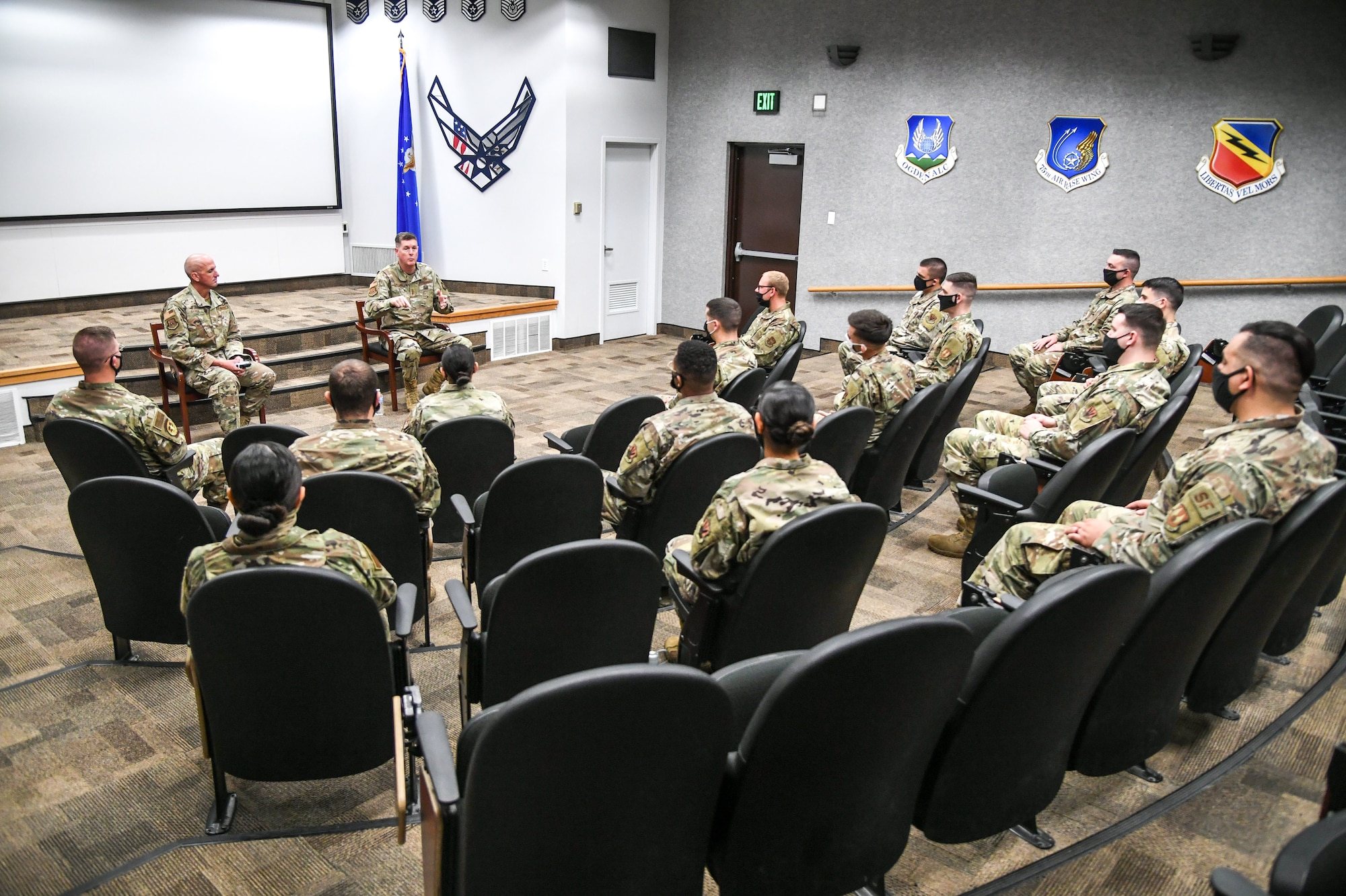 Airmen during Airman Leadership School seated and socially distanced in an auditorium.