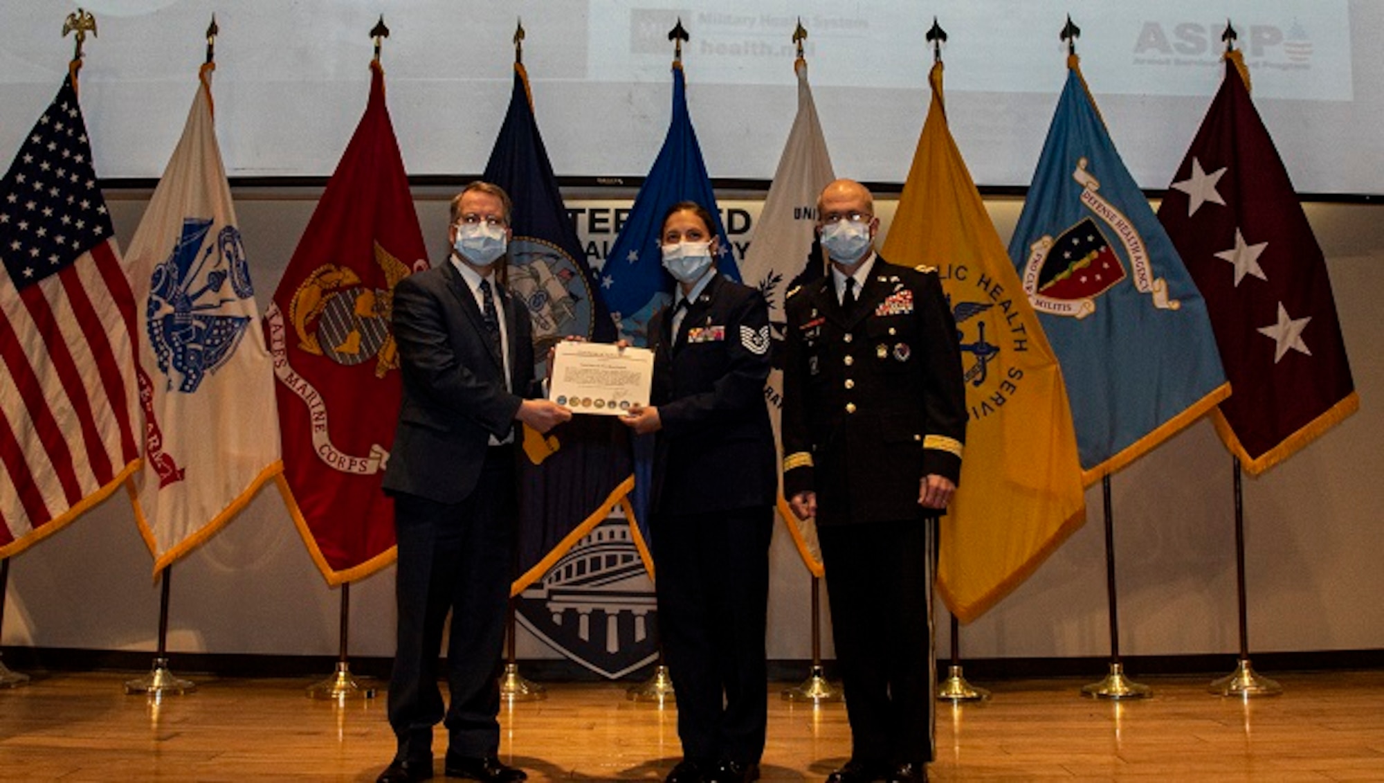 Image of Deputy Secretary of Defense David L. Norquist, left, and U.S. Army Lt. Gen. Ronald J. Place, right, and U.S. Air Force Tech. Sgt. Christina Swope
