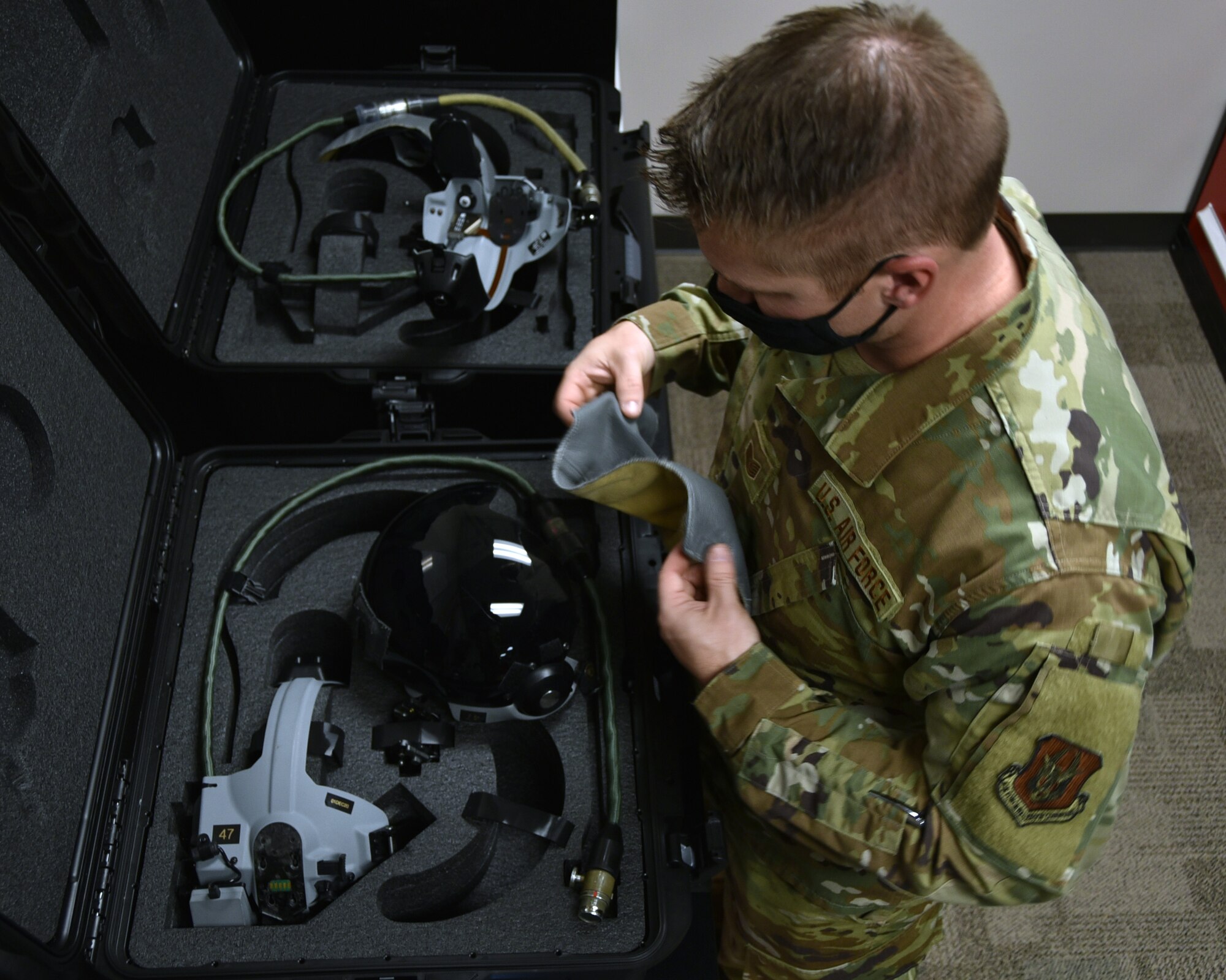 U.S. Air Force Tech. Sgt. Anthony Patterson, 301st Fighter Wing Operations Support Squadron aircrew flight equipment technician, inspects the Hybrid Optical-Based Inertial Tracker on a helmet at U.S. Naval Air Station Joint Reserve Base Fort Worth, Texas, Nov. 8, 2020. The HOBIT is a system that displays target information for the fighter pilot. (U.S. Air Force photo by Senior Airman Kedesha Pennant)