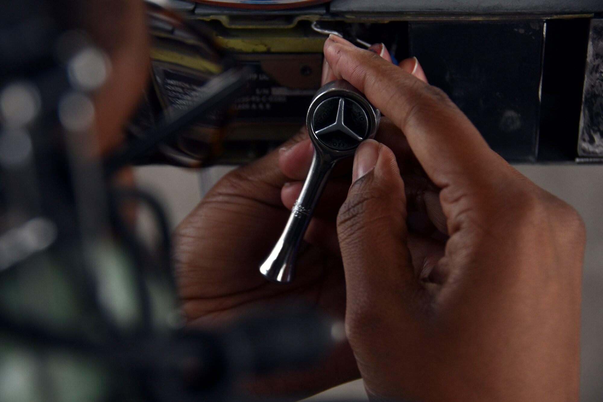 U.S. Air Force Tech. Sgt. Joelicia Louis, 301st Fighter Wing Maintenance Squadron electrical and environmental technician, removes wing tip formation lights on the right wing of an F-16 Fighting Falcon, at U.S. Naval Air Station Joint Reserve Base Fort Worth, Texas, Nov. 8, 2020. The removal facilitates additional wing maintenance prior to undergoing an x-ray. (U.S. Air Force photo by Senior Airman Kedesha Pennant)