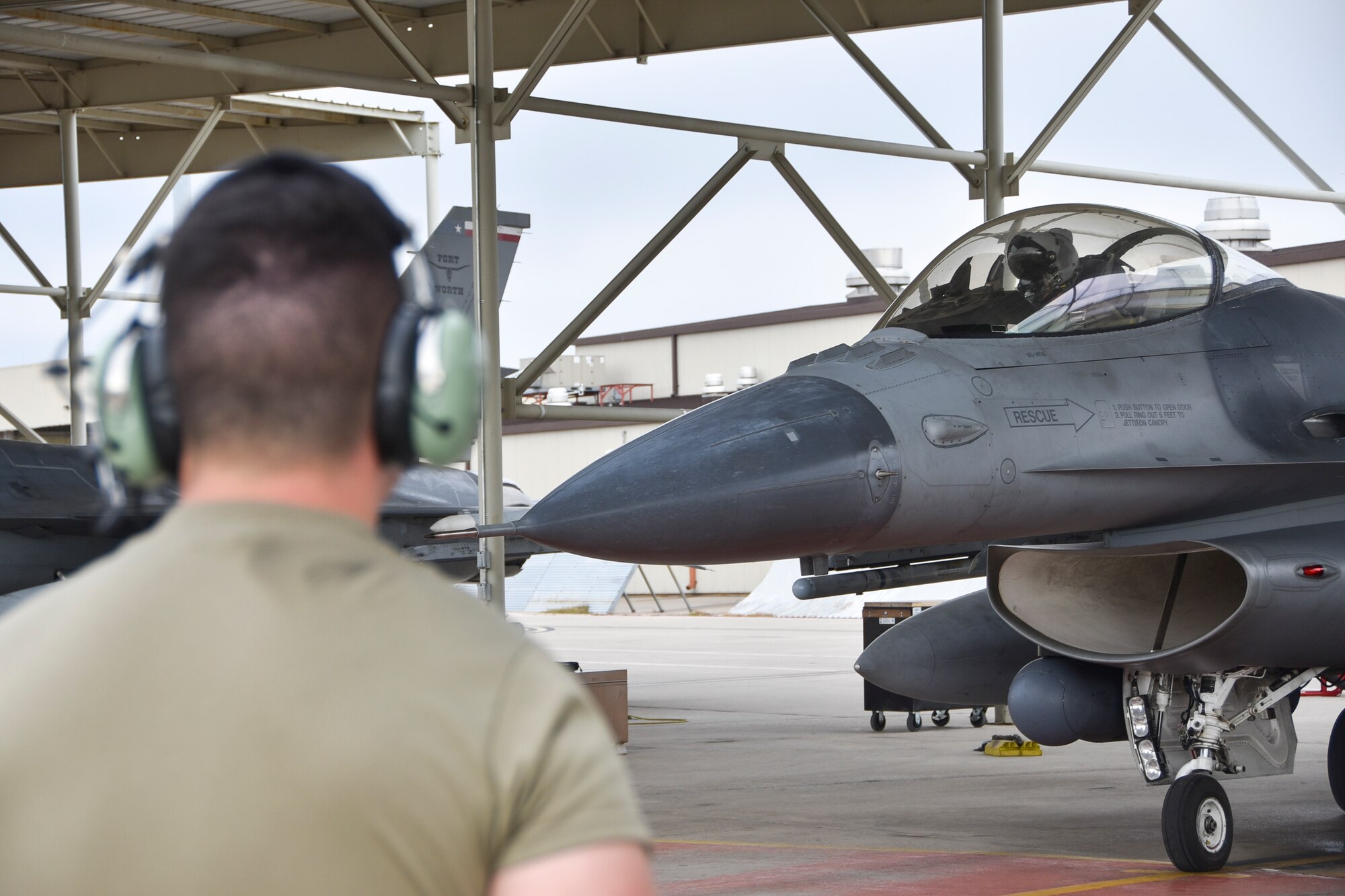 Senior Airman Daniel Hughes, 301st Fighter Wing Aircraft Maintenance Squadron crew chief, prepares to marshal an F-16 Fighting Falcon at U.S. Naval Air Station Joint Reserve Base Fort Worth, Texas, Nov. 8, 2020. The 301 FW Maintenance Group Aircraft participated in a surge, which is a training exercise which generates sorties at a much higher rate than usual to test readiness. (U.S. Air Force photo by Senior Airman Kedesha Pennant)