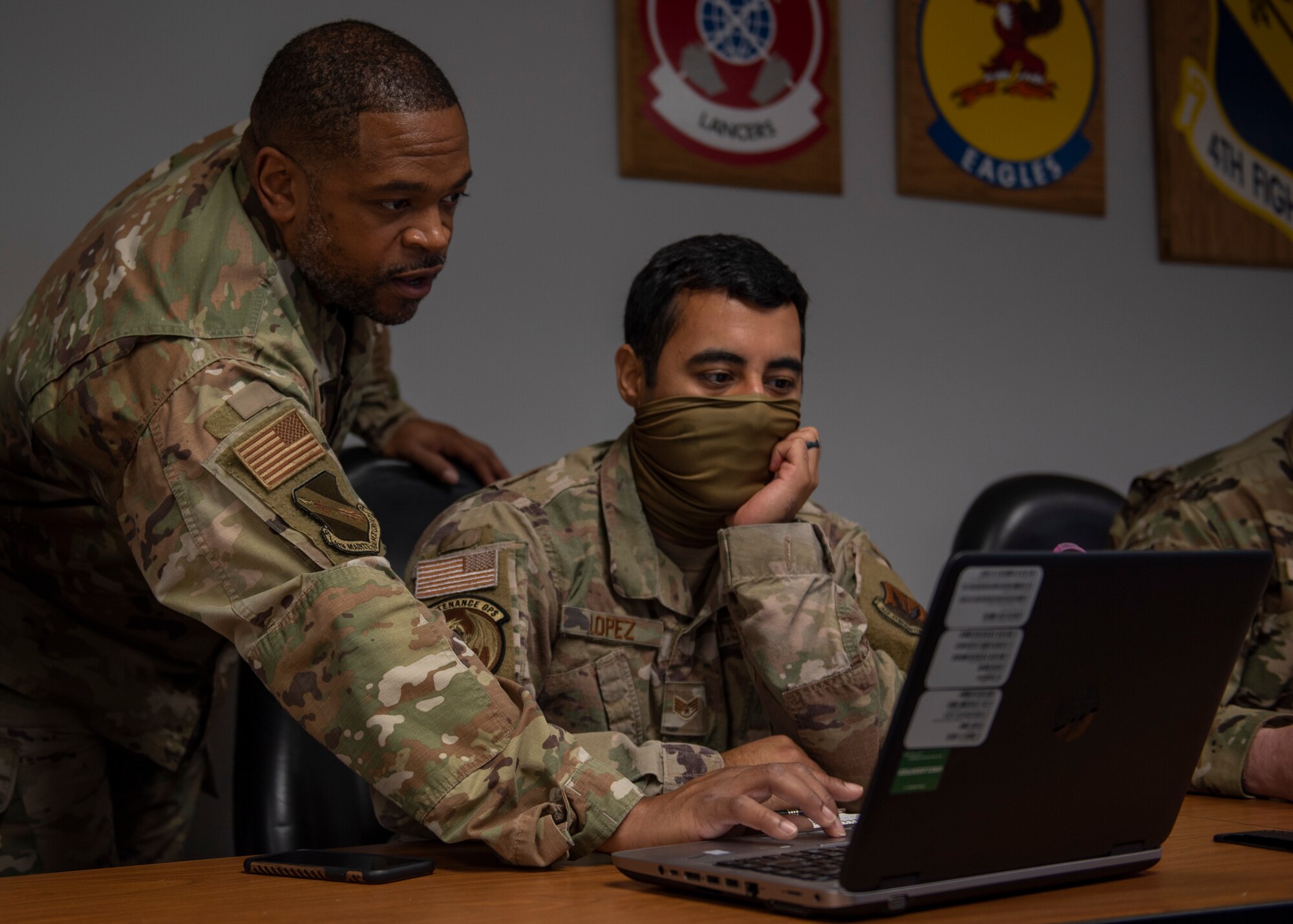 Tech Sgt. Jevon Charles, 4th Fighter Readiness Squadron weapons academic instructor (left), teaches Staff Sgt. George Lopez, 4 FRS aircraft maintenance qualifications program instructor (right), how to use formulas in Microsoft Excel at Seymour Johnson Air Force Base, North Carolina, Nov. 2, 2020.