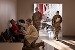 U.S. Air Force Chief Master Sgt. Jason France, center right, the U.S. Transportation Command senior enlisted leader, observes Staff Sgt. Travis Chadwick, center left, a 187th Aeromedical Evacuation Squadron aeromedical evacuation technician, as he tests a passenger, at Baltimore Washington International Thurgood Marshall Airport, November 9, 2020.  The COVID Response Team consists of more than five Air Force specialty codes including logistics, medical technicians, nurses, medical admin and an air transportation standards evaluation program manager. (U.S. Air Force Photo by Staff Sgt. Brittany A. Chase)