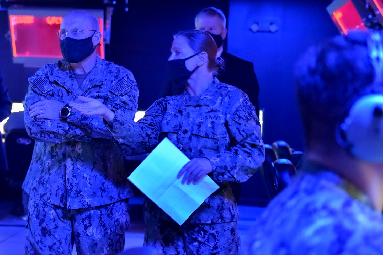 (Nov. 17, 2020) - Chief of Naval Operations (CNO) Adm. Mike Gilday speaks with Lt. Cmdr. Lisa Bydairk, the Integrated Air Missile Defense WTI Course Supervisor during a tour of the Reconfigurable Combat Information Center Trainer at the AEGIS Training and Readiness Center (ATRC) in Dahlgren, Virginia, Nov. 17. CNO traveled to Dahlgren to visit Sailors and civilians and receive briefs on a variety of programs like High Energy Lasers, Solid Laser Technology Maturation (SSL-TM) and Layered Laser Defense (LLD).  (U.S. Navy photo by Lieutenant Rachel Maul/Released)