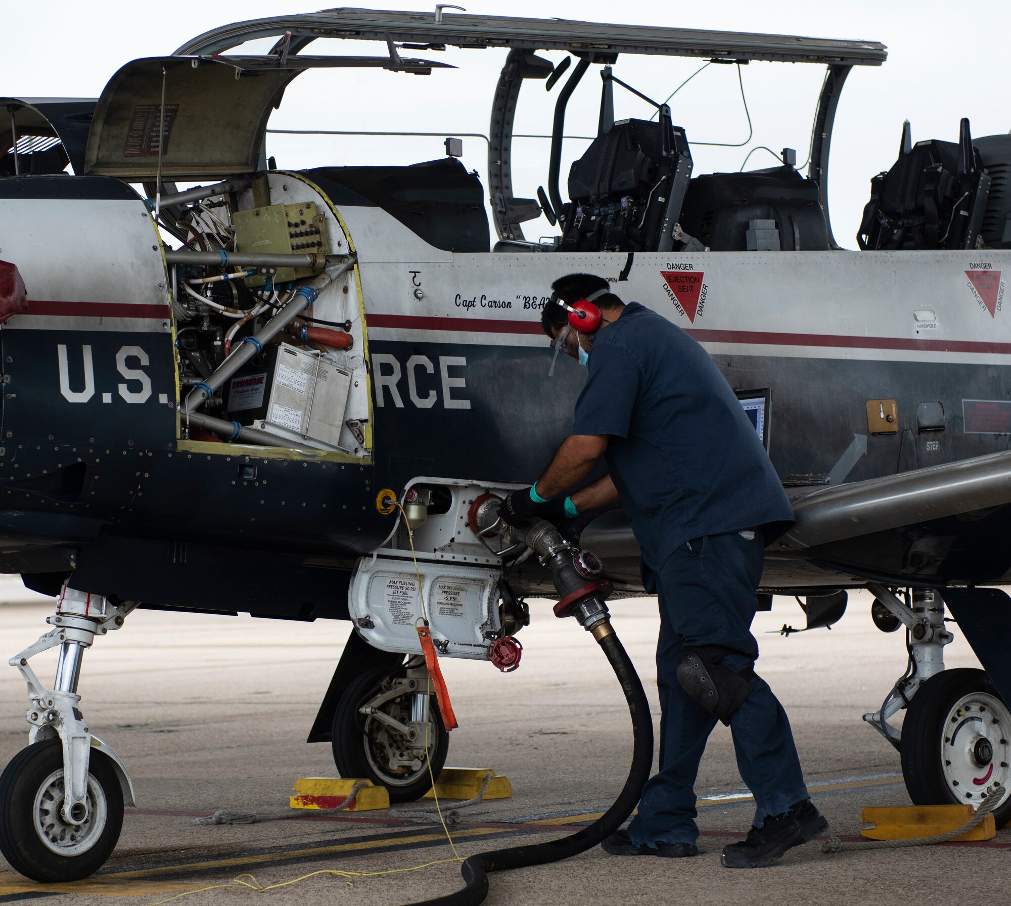 Javier Martinez Jr, 47th Flying Training Wing Maintenance aircraft worker, refuels a Texan T-6 II on the flight line, on Nov. 9 2020, Laughlin Air Force Base, Texas. He is utilizing the new commercial 3K refueler vehicle that is being tested. (U.S. Air Force photo by Airman 1st Class David Phaff)