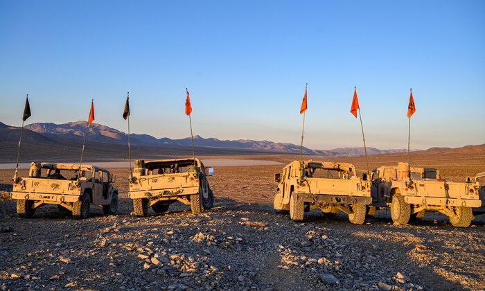 Humvees parked on a hill.