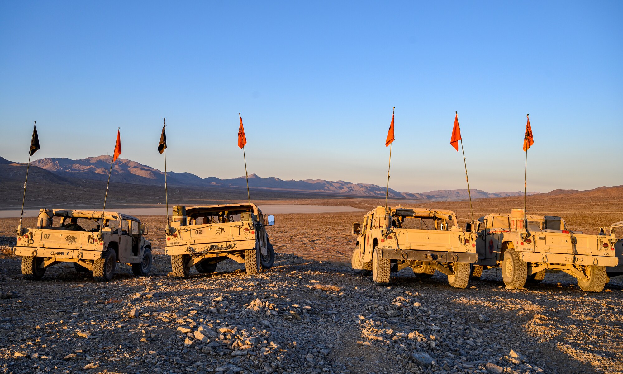 Humvees parked on a hill.