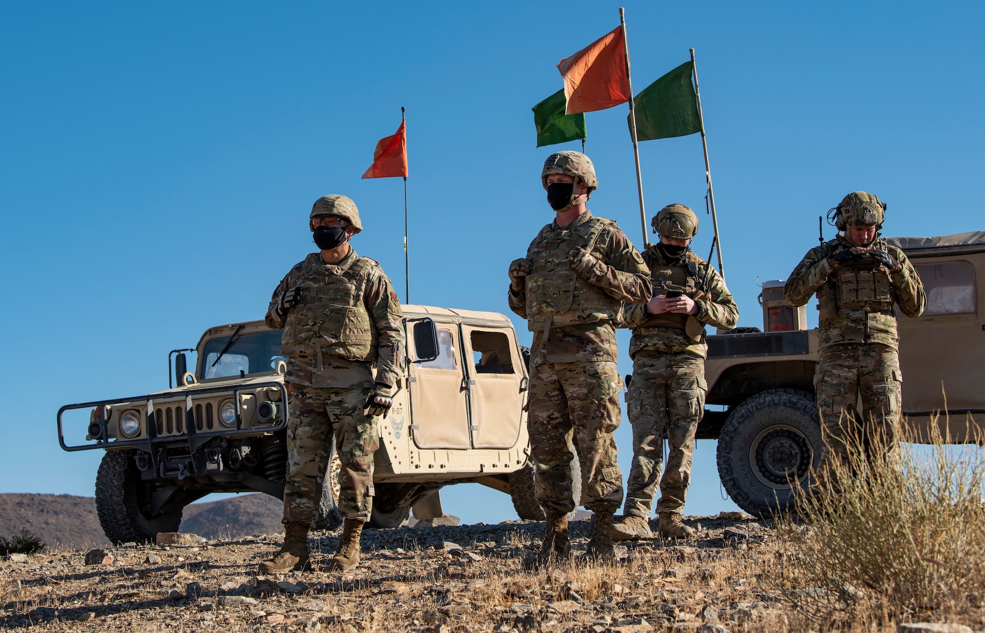 Airmen stand on a hill.