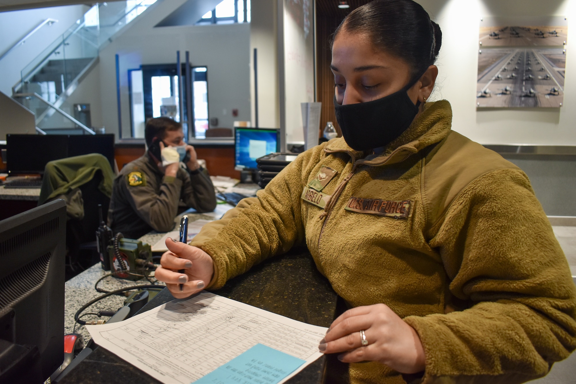 A photo of Airman Ashley Arbelo, a Squadron Aviation Resource Manager, working at the operations desk while pilots are flying sorties at Hill Air Force Base, Utah.