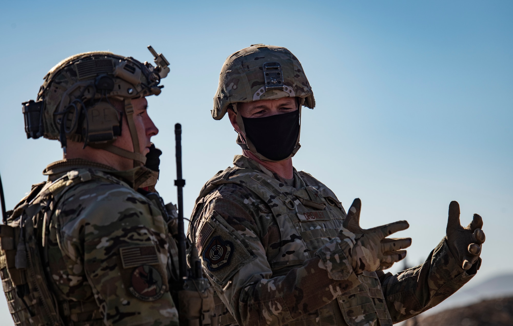 Airmen talk on a hill.