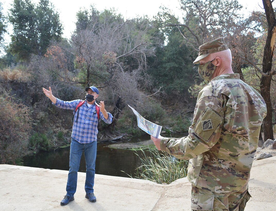 Jim Hutchison, U.S. Army Corps of Engineers Los Angeles District lead planner for the Malibu Ecosystem Restoration Project, left, discusses plans for the project with Brig. Gen. Paul Owen, the Corps’ South Pacific Division commanding general, right, during an Oct. 6 site tour of the project near Calabasas, California. Lt. Gen. Scott Spellmon, the Corps’ commanding general and 55th U.S. Army chief of engineers, signed the chief’s report for the project Nov. 13 at the Corps’ headquarters in Washington D.C., which now elevates the report to the Assistant Secretary of the Army for Civil Works, U.S. Office of Management and Budget, and to Congress for consideration of project authorization.