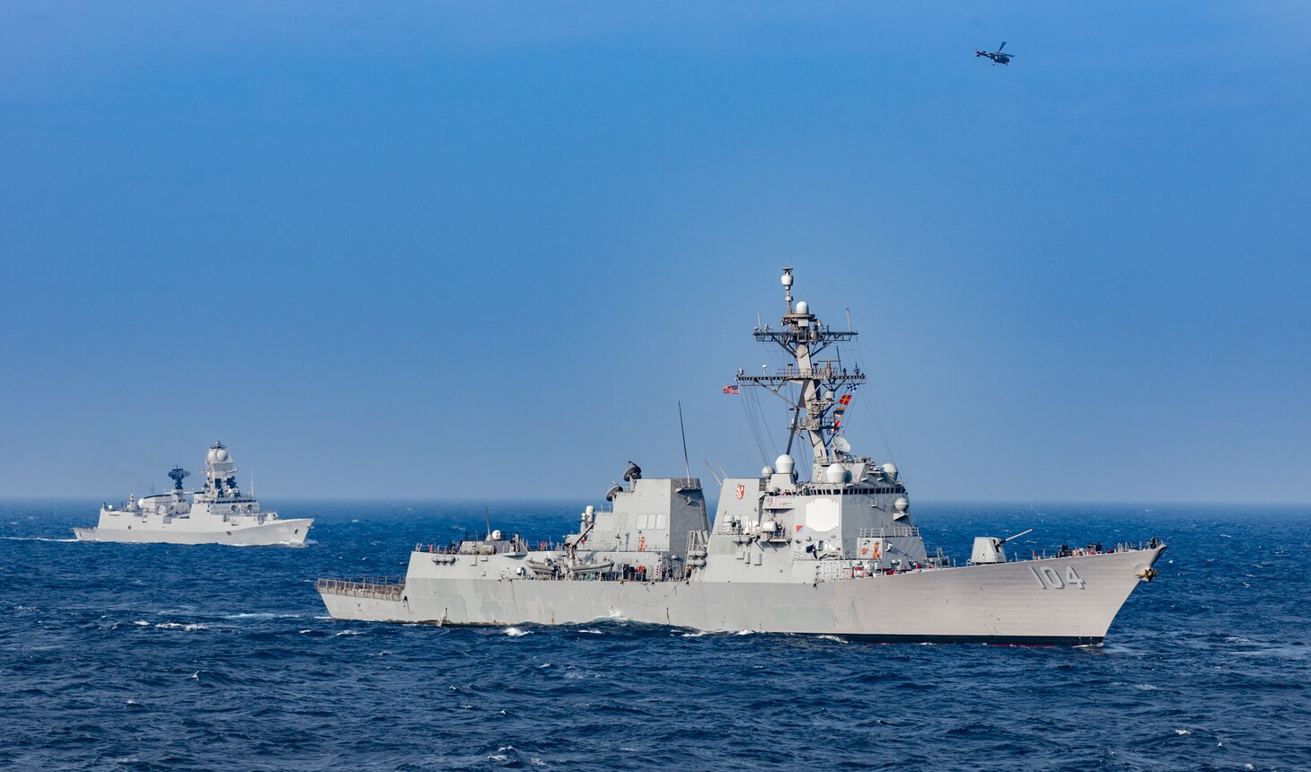 USS Sterett (DDG 104) and the Indian navy stealth guided-missile destroyer INS Kolkata steam in formation while participating in Malabar 2020 in the north Arabian Sea.