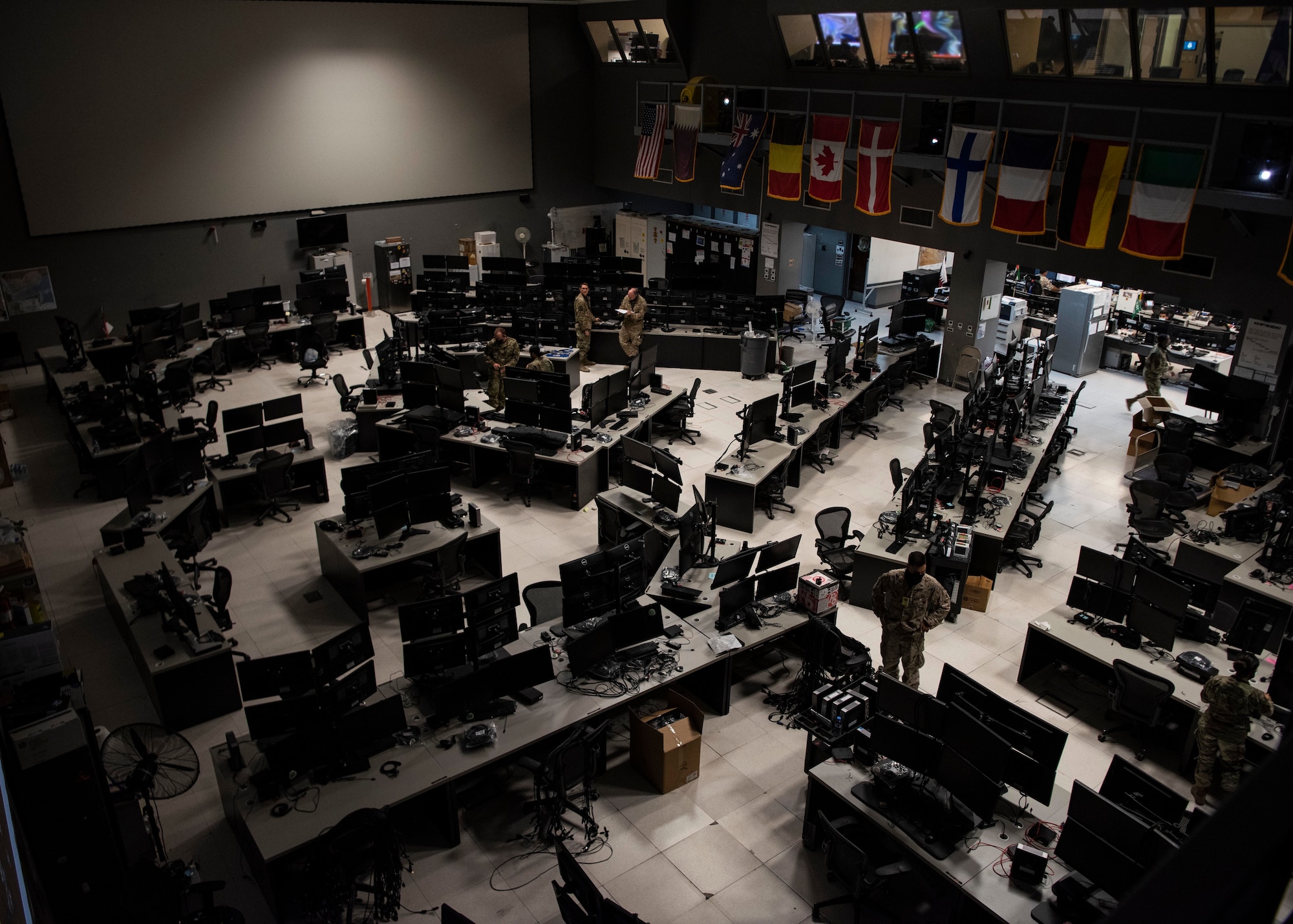 U.S. Air Force Airman 1st Class Jaren Rutledge (right) and Senior Airman TJ Rogacion (left), 379th Expeditionary Civil Engineer Squadron electrical systems specialists, work on a computer server rack in the Combined Air Operations Center, Al Udeid Air Base, Qatar, Oct. 26, 2020.