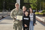 Command Master Chief Petty Officer T.R. Glazner, from Lexington, North Carolina, assigned to Trident Refit Facility, Bangor, stands alongside his wife, Arwen, and children, Wyatt and Addisyn, after accepting the Naval Submarine League’s 2020 Fleet Master Chief Frank A. Lister award, Sept. 16.