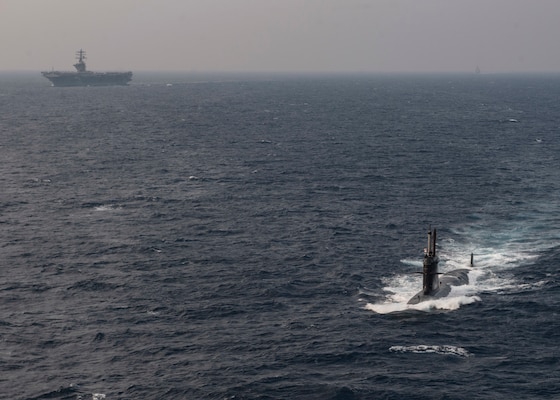 The Indian navy submarine INS Khanderi, steams ahead of the aircraft carrier USS Nimitz (CVN 68) and the guided-missile cruiser USS Princeton (CG 59) while participating in Malabar 2020.