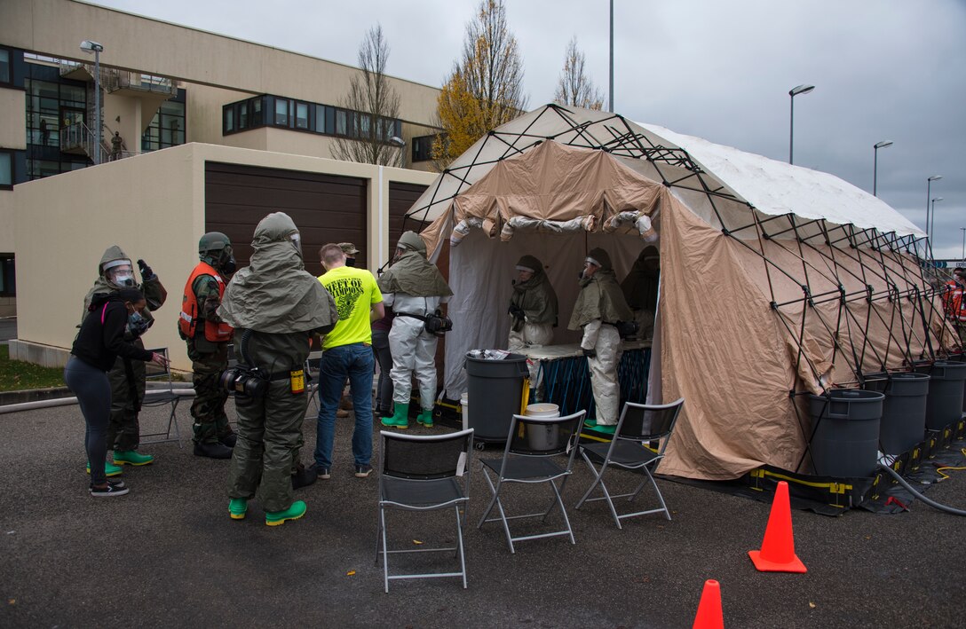 U.S. Air Force Airmen assigned to the 52nd Medical Group assess mock patients during an exercise at an in-place patient decontamination tent at Spangdahlem Air Base, Germany, Nov. 17, 2020. The IPPD is set up to decontaminate patients and to prevent the spread of possible chemical exposure to the medical facility. (U.S. Air Force photo by Senior Airman Chance D. Nardone)