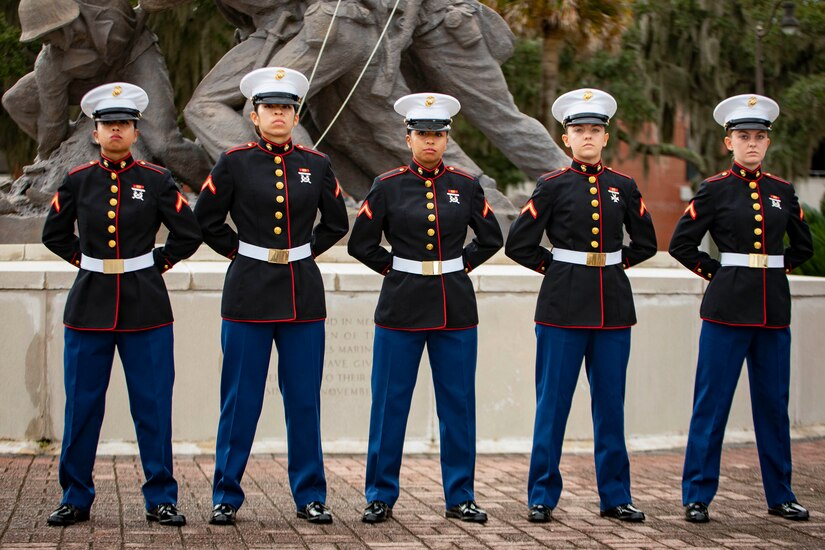 Five Marines stand in a row for a photo.
