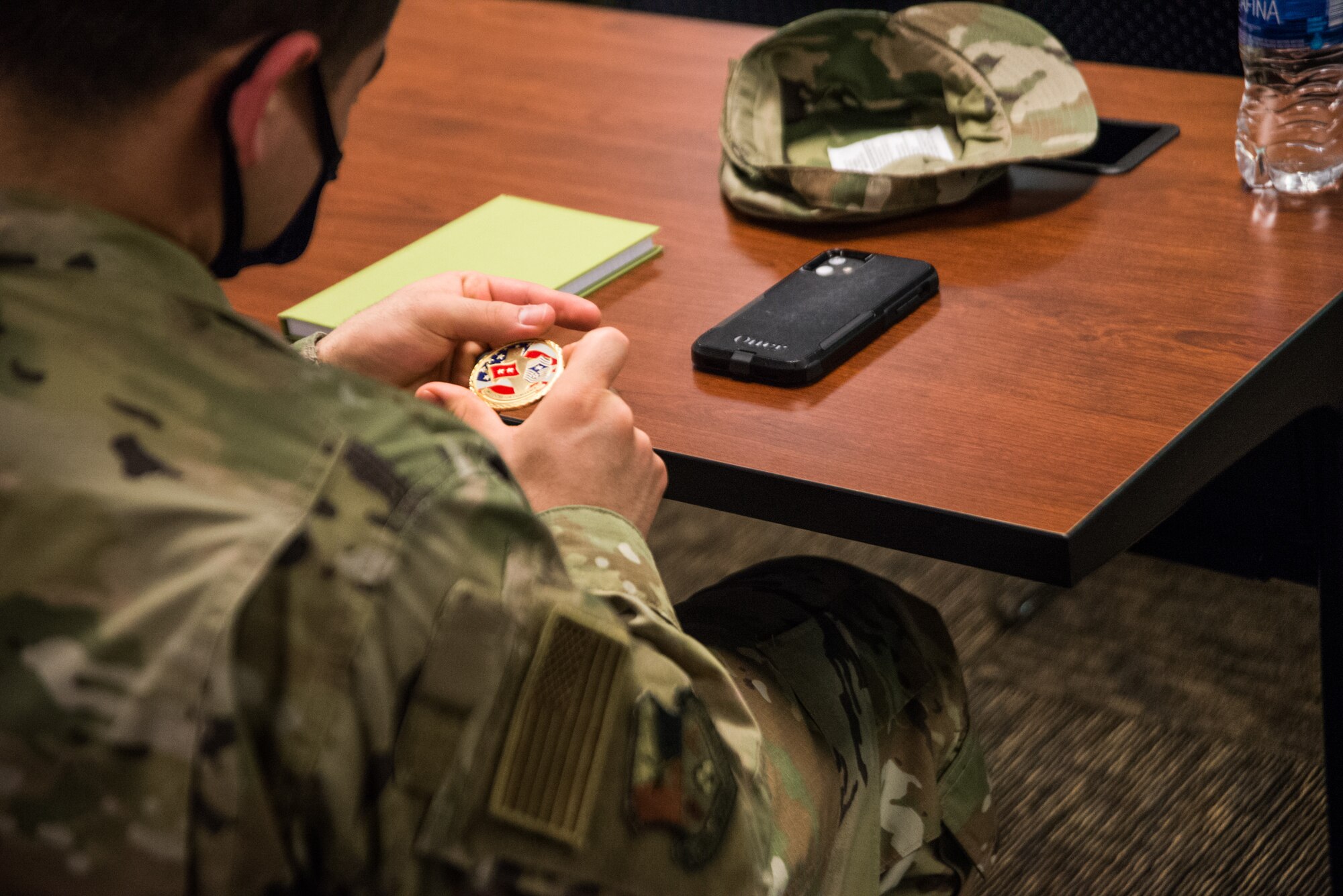 Airmen examines military coin