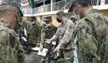 A Soldier of the 14th Missile Defense Battery, Kyogamisaki Communication Site, Kyotango-Shi, Japan, instructs soldiers of the Japan Ground Self-Defense Force on the operation of a crew-served machine gun during a U.S.-Japan multinational joint force field training exercise, Nov. 2-3. The battery is operated by the U.S. Army Space and Missile Defense Command’s 1st Space Brigade. (Courtesy photo)