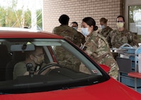 Photo of Airmen administering flu vaccines