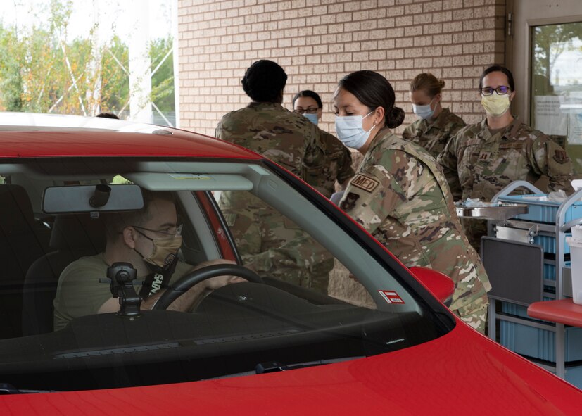 Photo of Airmen administering flu vaccines