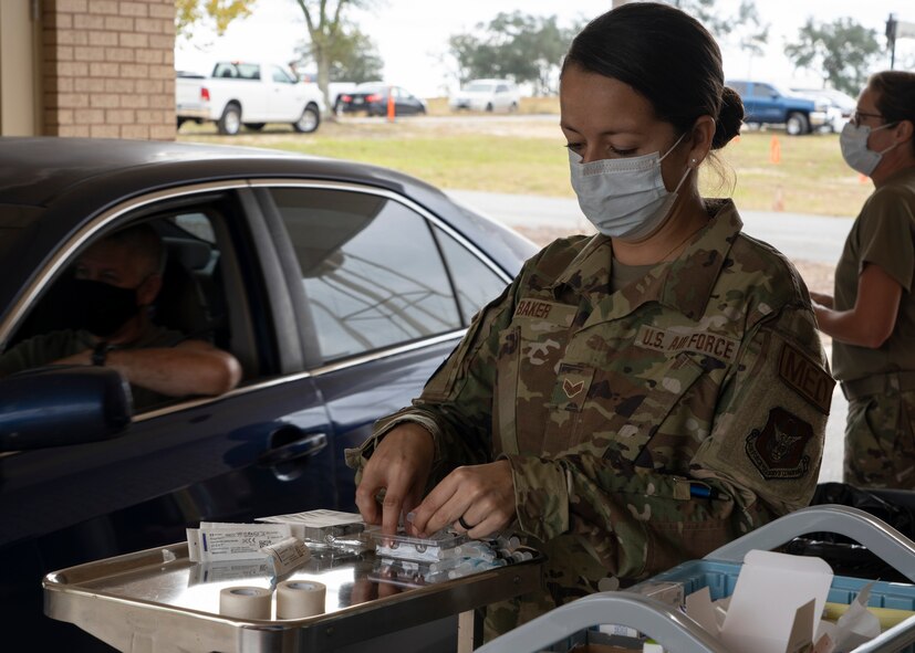 Photo of an Airman preparing a flu vaccination.