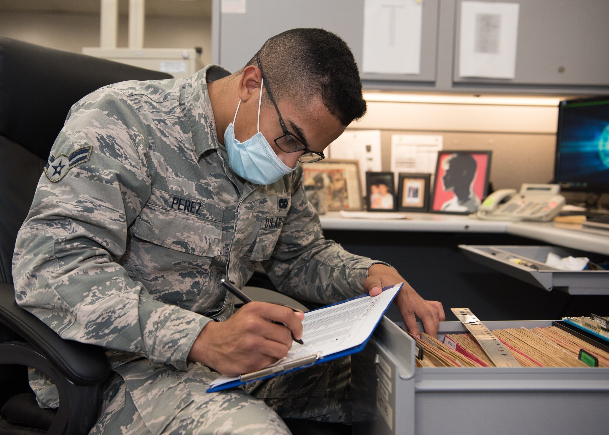 Airman 1st Class Gabriel Perez, 509th Logistics Readiness Squadron fleet management and analysis sorts files while sitting in his office.