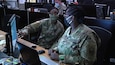 377th Theater Sustainment Command Soldiers discuss plans at the Belle Chasse, La. based Command Operations and Information Center prior to the cumulative tabletop exercise, Nov. 13, 2020.