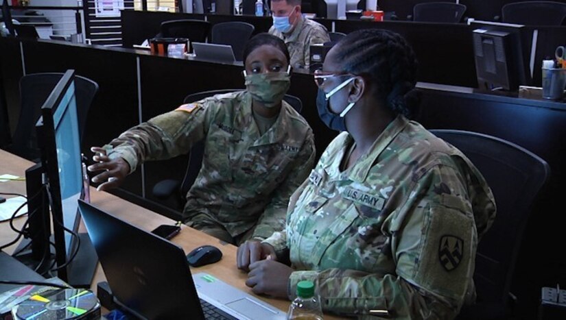 377th Theater Sustainment Command Soldiers discuss plans at the Belle Chasse, La. based Command Operations and Information Center prior to the cumulative tabletop exercise, Nov. 13, 2020.