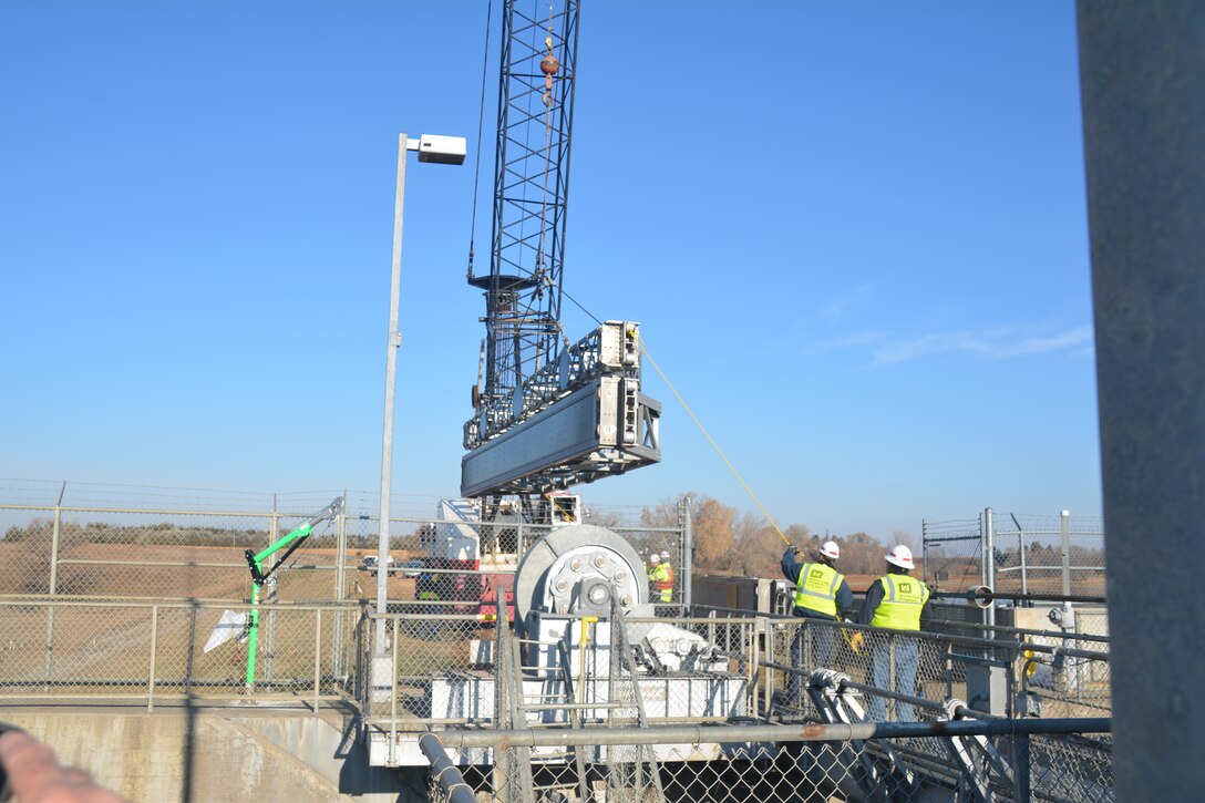 A crane lowers a bulkhead into the water