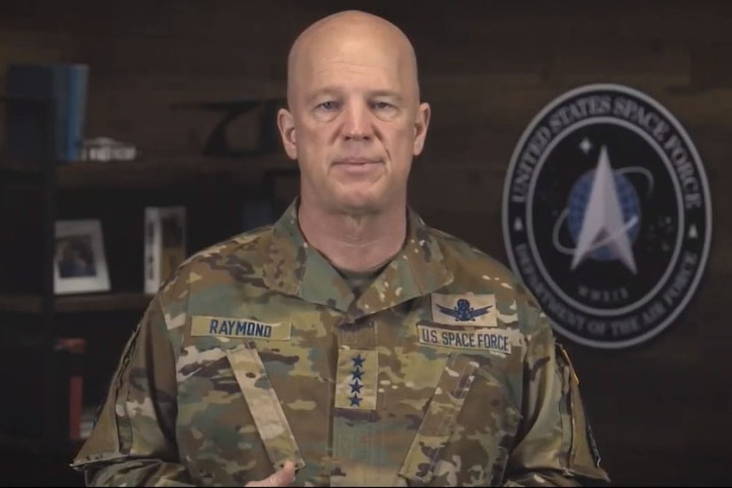 A man in a military uniform looks at the camera.