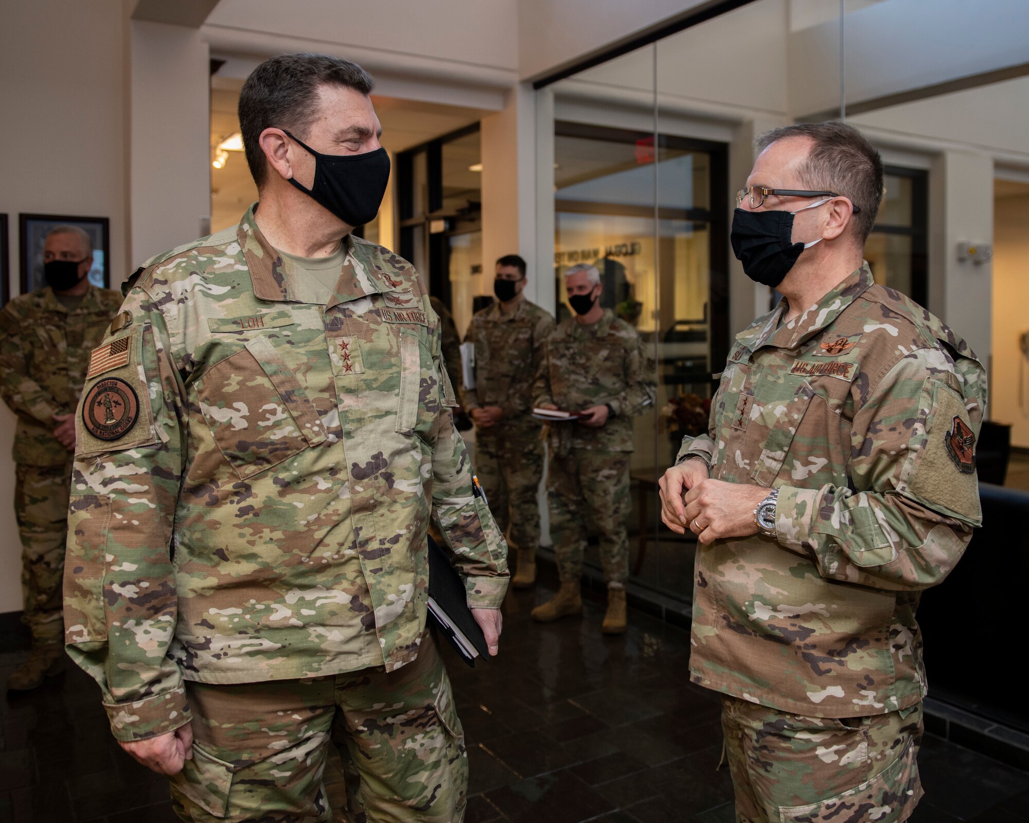 U.S. Air Force Lt. Gen. Jim Slife, left, commander of Air Force Special Operations Command, speaks with U.S. Air Force Lt. Gen. Michael Loh, director of the Air National Guard, during a base visit on Hurlburt Field, Florida, Nov. 18, 2020.