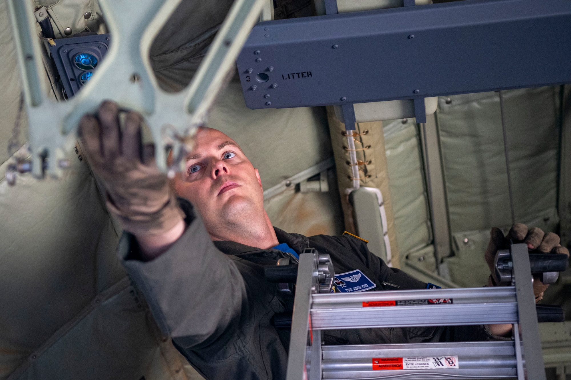 A loadmaster sets up a C-130J Super Hercules for static-line jumps.
