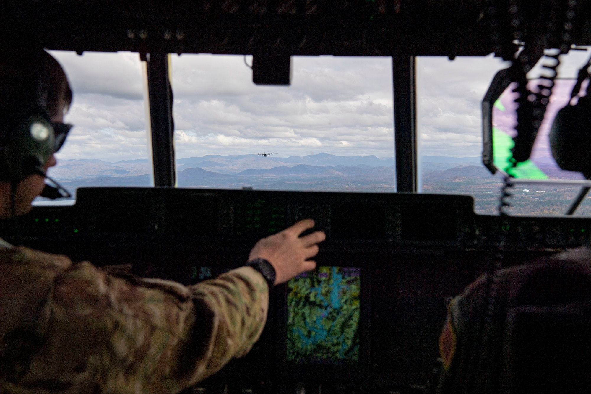 A pilot follows another C-130J Super Hercules over West Virginia.