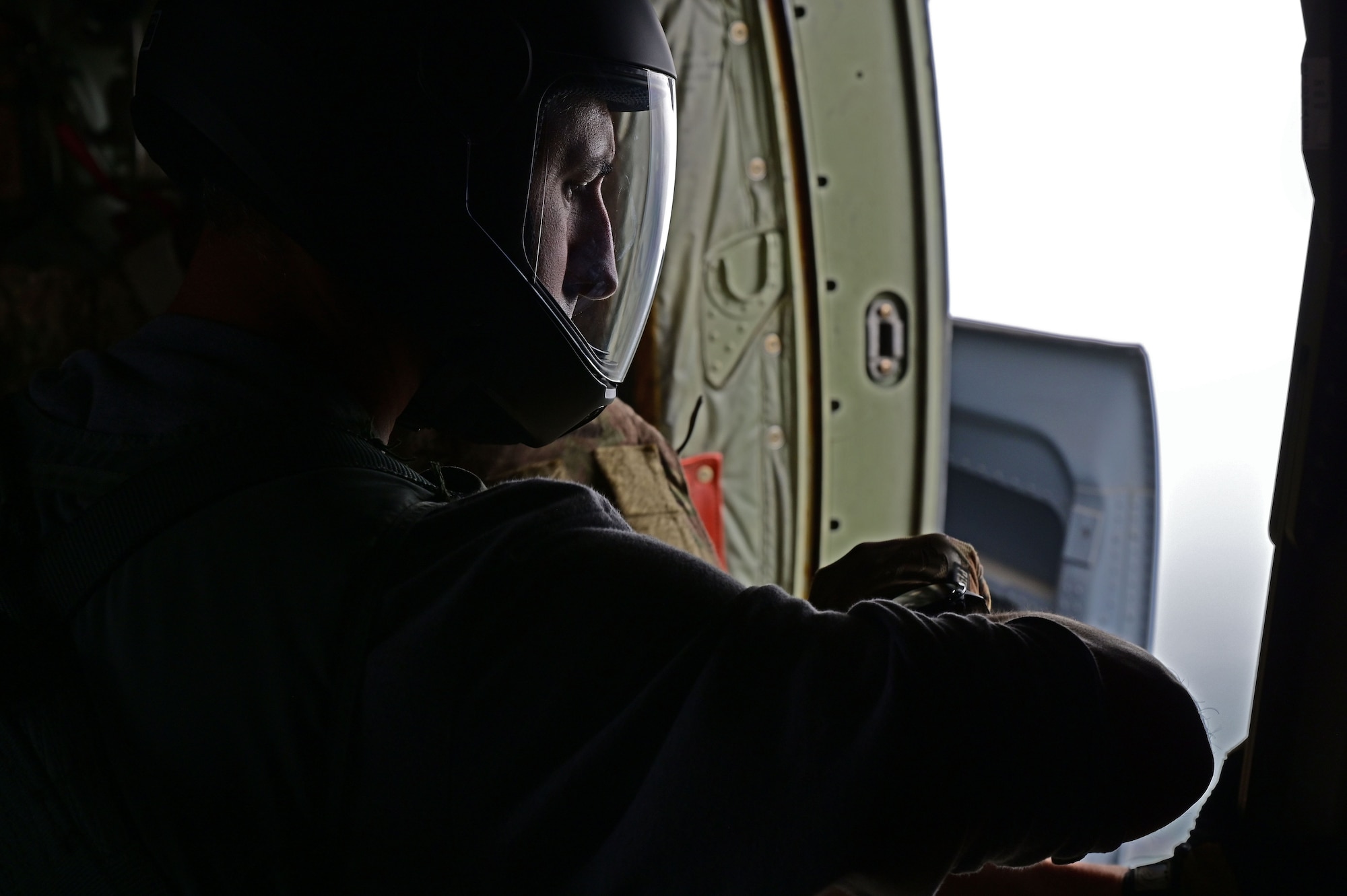 A man looks at his watch on a C-130J Super Hercules.