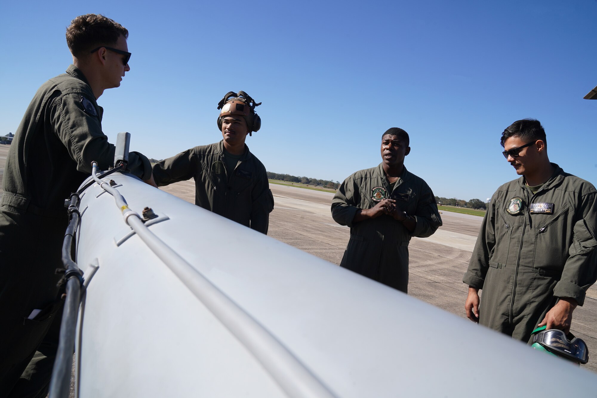 U.S. Marine Corps Marines converse before a flight on the flightline at Keesler Air Force Base, Mississippi, Nov. 17, 2020. Marines came to Keesler to conduct routine training operations in and around the Mississippi area. (U.S. Air Force photo by Airman 1st Class Seth Haddix)